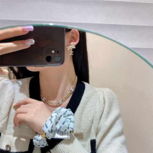 High Quality Luxury Chanel Creamy White Bow Earrings alternate view