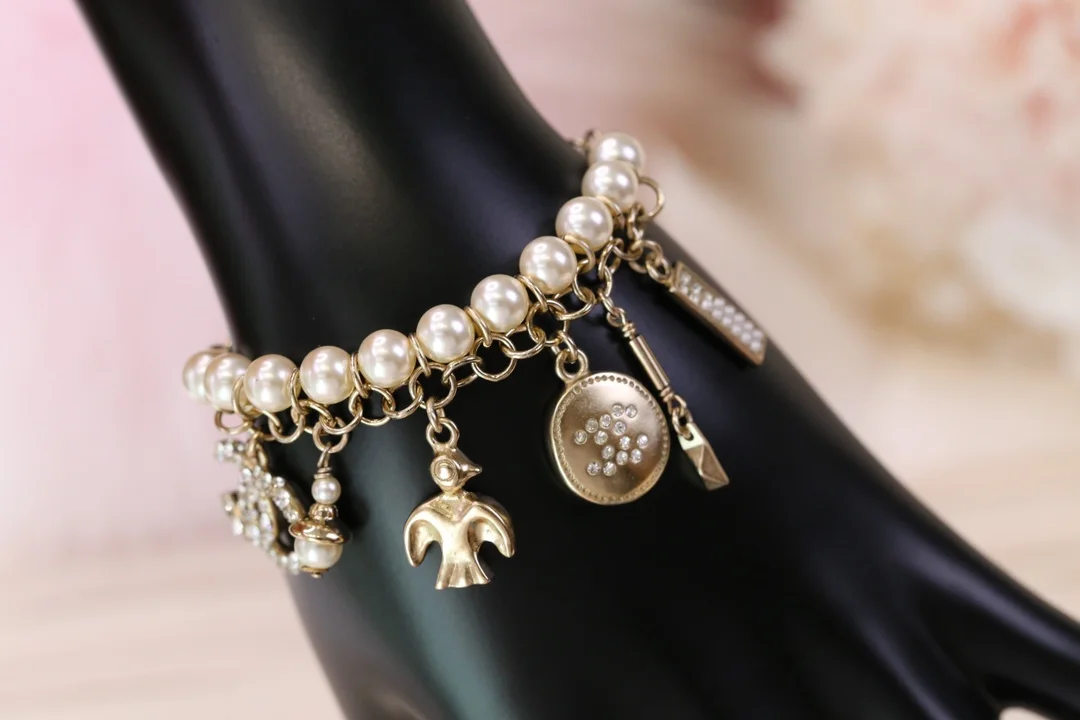 Chanel Bird CC Pearl-Effect Tassel Charm Bracelet Gold-Tone product view 1